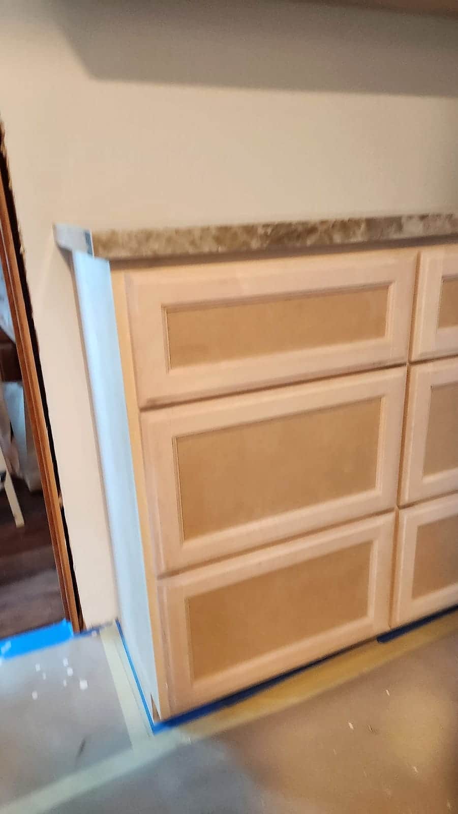 Bathroom vanity drawers primed under a marble counter