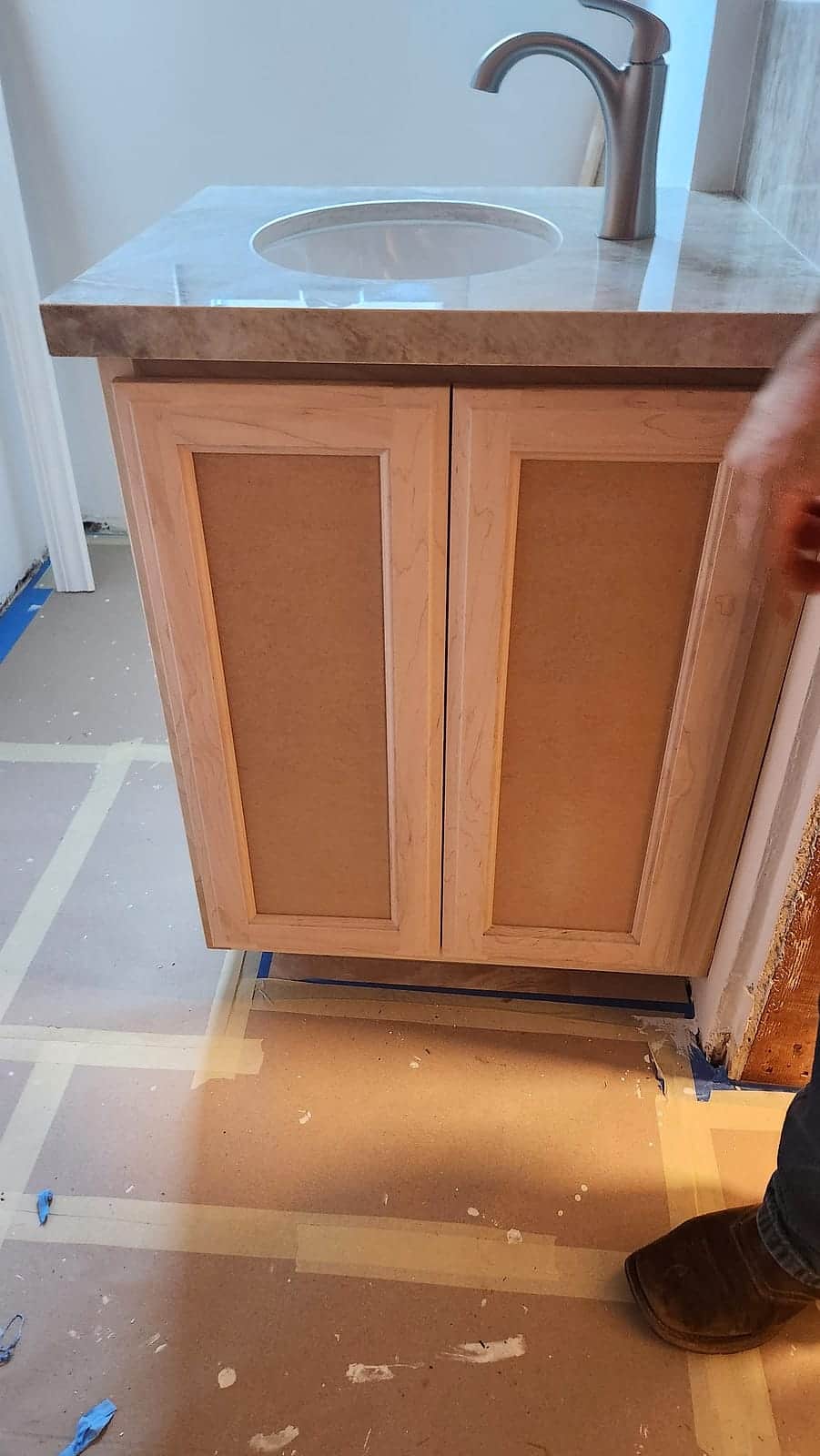 Vanity cabinet primed and prepped beneath the sink