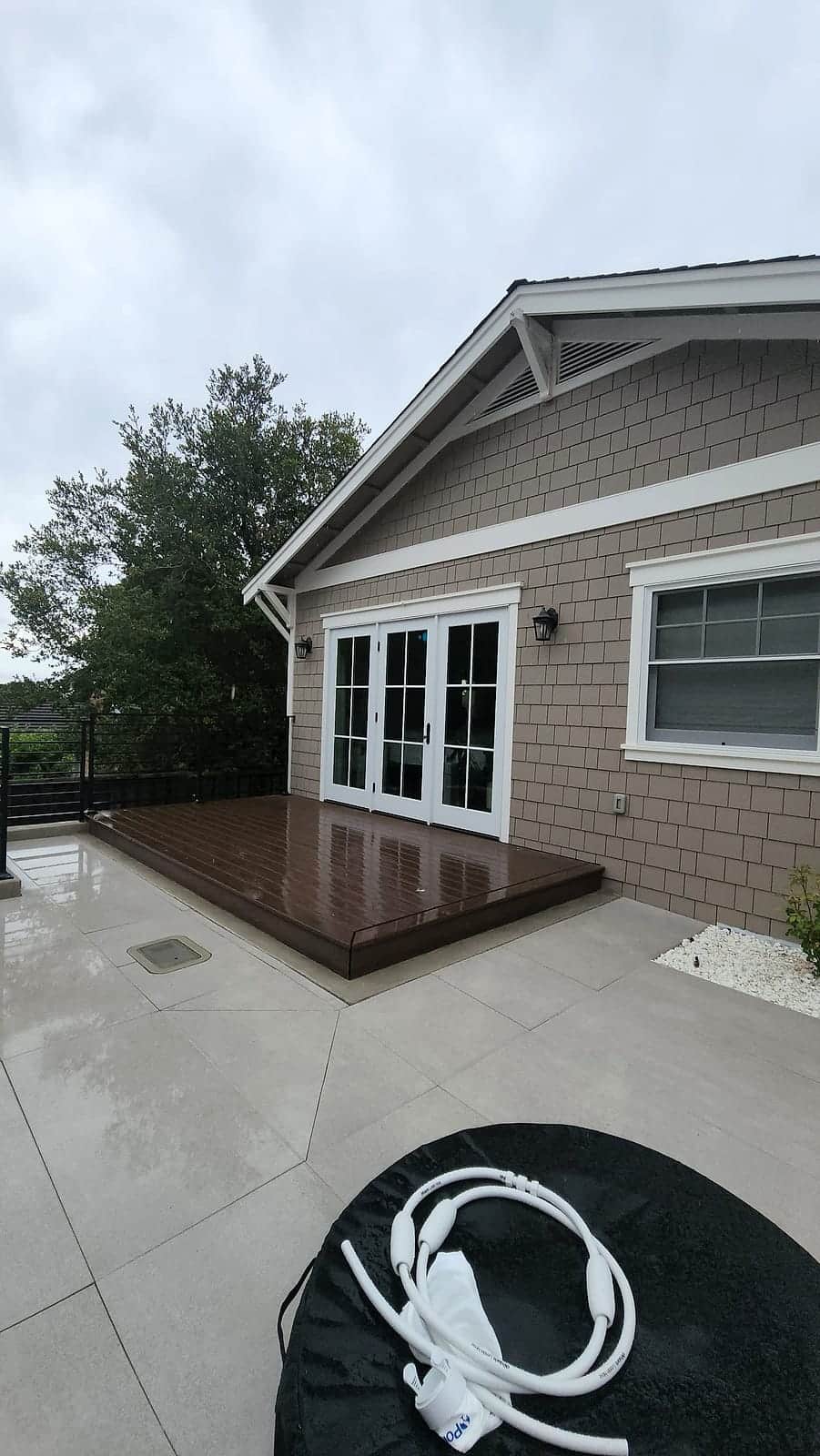 New composite deck platform behind a freshly painted shingle home