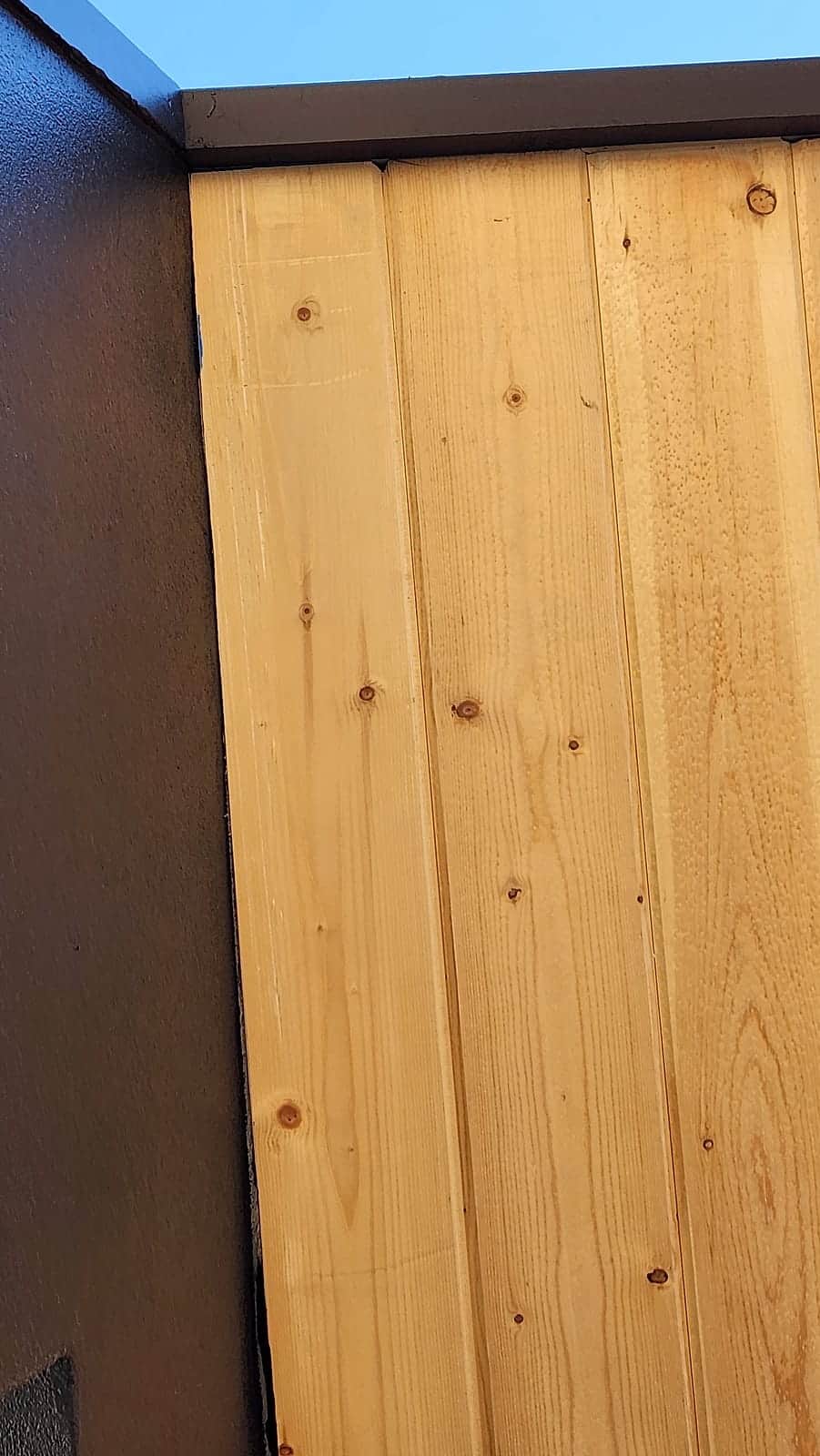 New cedar gate panel set in a black steel frame