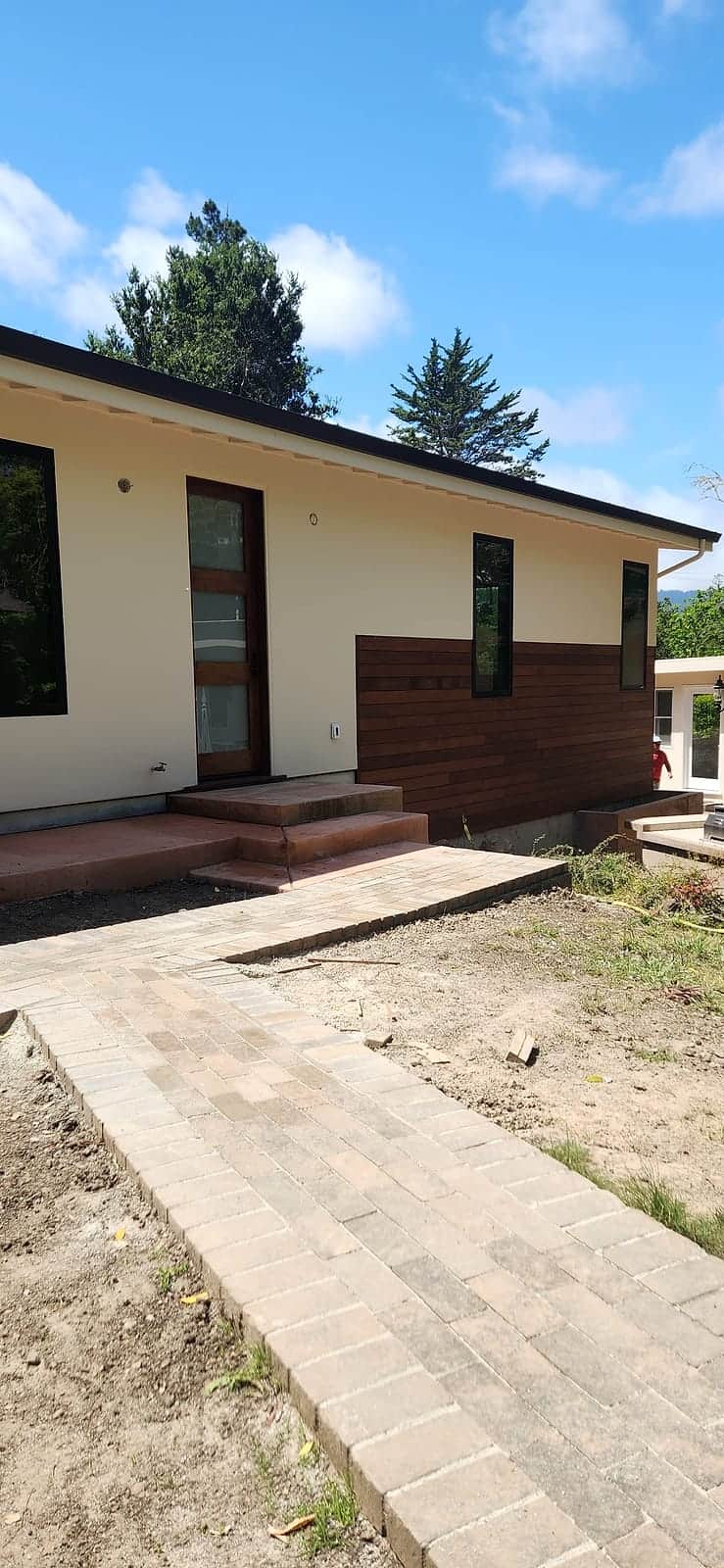 Repainted single-story home with warm cream walls and a wood-slat accent entry