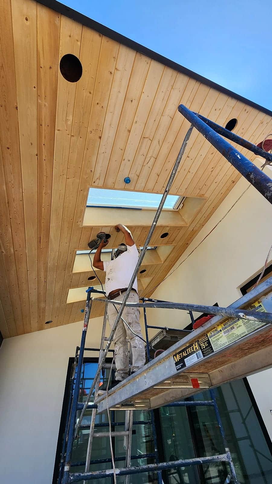Finishing a vaulted wood-plank ceiling around a skylight