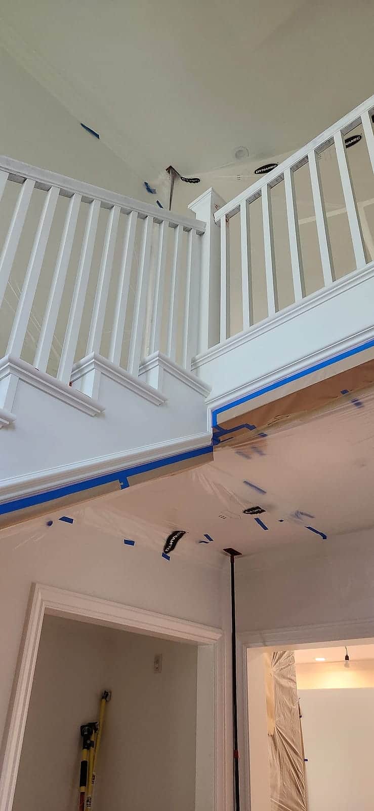 Two-story foyer with freshly painted white railings and trim