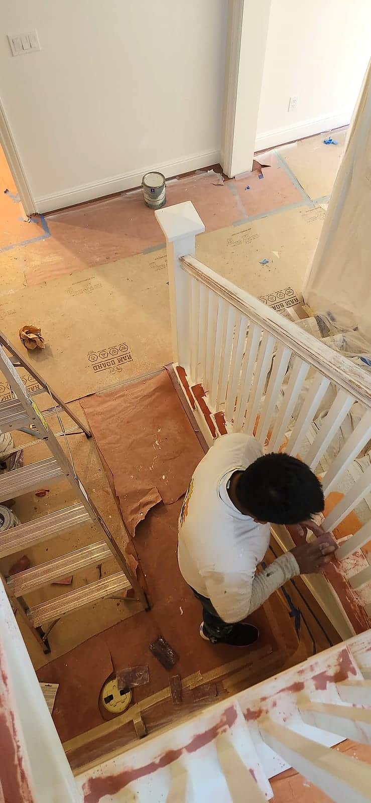 Painting a staircase balustrade with floors fully masked and protected